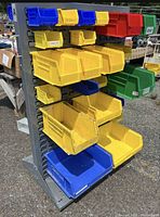 Front view of grey steel rack with multiple coloured bins attached