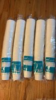 Five sealed sleeves of Highmark 12-oz hot cups on floor