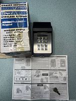 Keypad unit, box and manual visible on counter