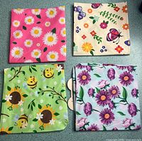 Four folded pet bandanas showing different patterns