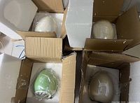 Four porcelain eggs secured in original boxes
