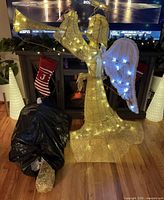Assembled lit gold angel with bagged second angel beside