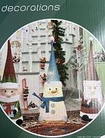 Box showing three 45" cone-shaped Christmas figures: elf, snowman and Santa