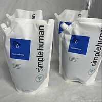 Front view of four simplehuman spring water soap pouches