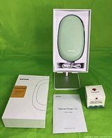 Printer in open packaging with cable, booklet, and label roll