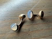 Front view showing moonstone cabochons and gold backs