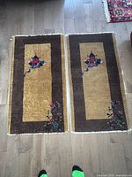 Pair of rugs laid flat showing full design and size reference