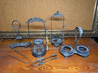 Group shot of all cruet frames, glass jar and tongs on table