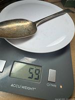 Spoon on scale showing 59 g