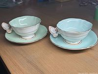 Two teacup and saucer sets on table