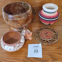 Group shot showing burl wood bowl, painted vase, terracotta bowl, small animal figurine, and roadrunner trivet