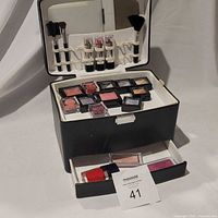 overall view of open cosmetic train case showing contents