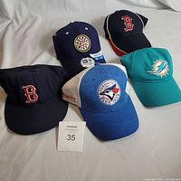 Group of five sports caps front view
