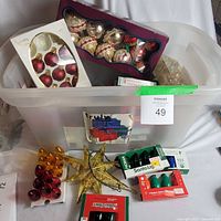 Entire bin showing ornaments, boxed bulbs and star topper