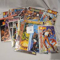Group of 28 bagged comic books spread out