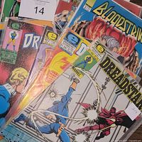 Front view of grouped comics showing Bloodstrike and Dreadstar covers in sleeves
