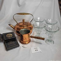 Group shot: teapot, saucepan, coasters, four glasses
