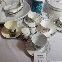 Close-up of pitcher, bowl, gravy boat, canister, sugar bowl, shakers, and teacups