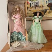Both dolls side by side showing Cyrena in box and Scarlett displayed