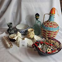 Group shot of all items in lot showing decanter, bottles, bowls, dish, figurine and jewelry