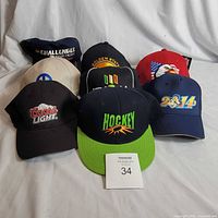 All seven caps arranged front and back rows