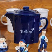 Front view of teapot, mugs and three figurines