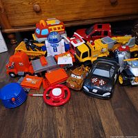 Group shot of all toy vehicles and accessories on floor