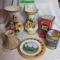 Front view of lot showing both vases, tins, plate, lampshade