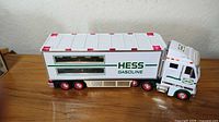 Left side view of Hess 2003 tractor-trailer on wood surface