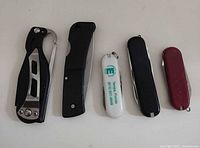 Front view of all five knives closed, showing size and handle styles