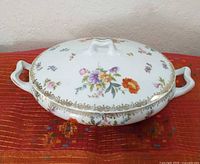 Top view of covered casserole showing floral design and handles