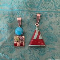 Rectangular multi-stone pendant and triangular inlay pendant