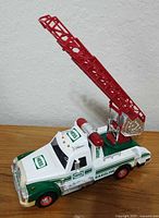 Front left view showing Hess firetruck with ladder raised