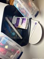 Overview of contents inside black tote with bins and tools visible