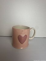 Front view of pink mug with embossed heart
