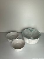 Casserole with lid and two ramekins, frontal view