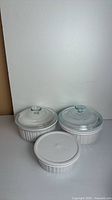 Full set with two casseroles shown with glass lids and third with plastic lid