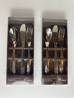 Front view of two boxed 3-piece children’s cutlery sets