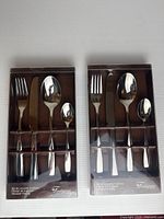Two boxed Fontignac 4-piece cutlery sets front view