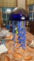 Full view of jellyfish ornament hanging, showing dome and tentacles
