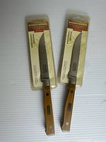 Front view of both sealed steak knives showing bamboo handles and serrated blades