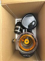 Juicer parts packed in styrofoam inside shipping box