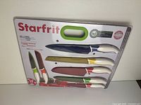 Front view of sealed Starfrit 14-piece knife set packaging showing knives and sheaths
