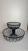 Front view of two-tier wire fruit basket stand