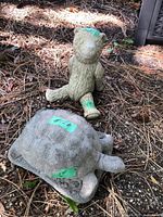 Turtle and teddy bear statues together outdoors