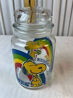 Front view of glass jar with Snoopy, rainbow and Goodies text