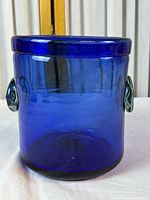 Front view of cobalt blue glass bucket showing cylindrical shape and one applied handle