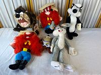 Group shot of all six plush dolls on table