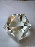 Faceted crystal paperweight showing etched Playboy Bunny logo on top face