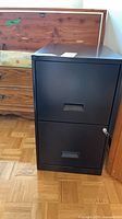 Front view of black 2-drawer filing cabinet